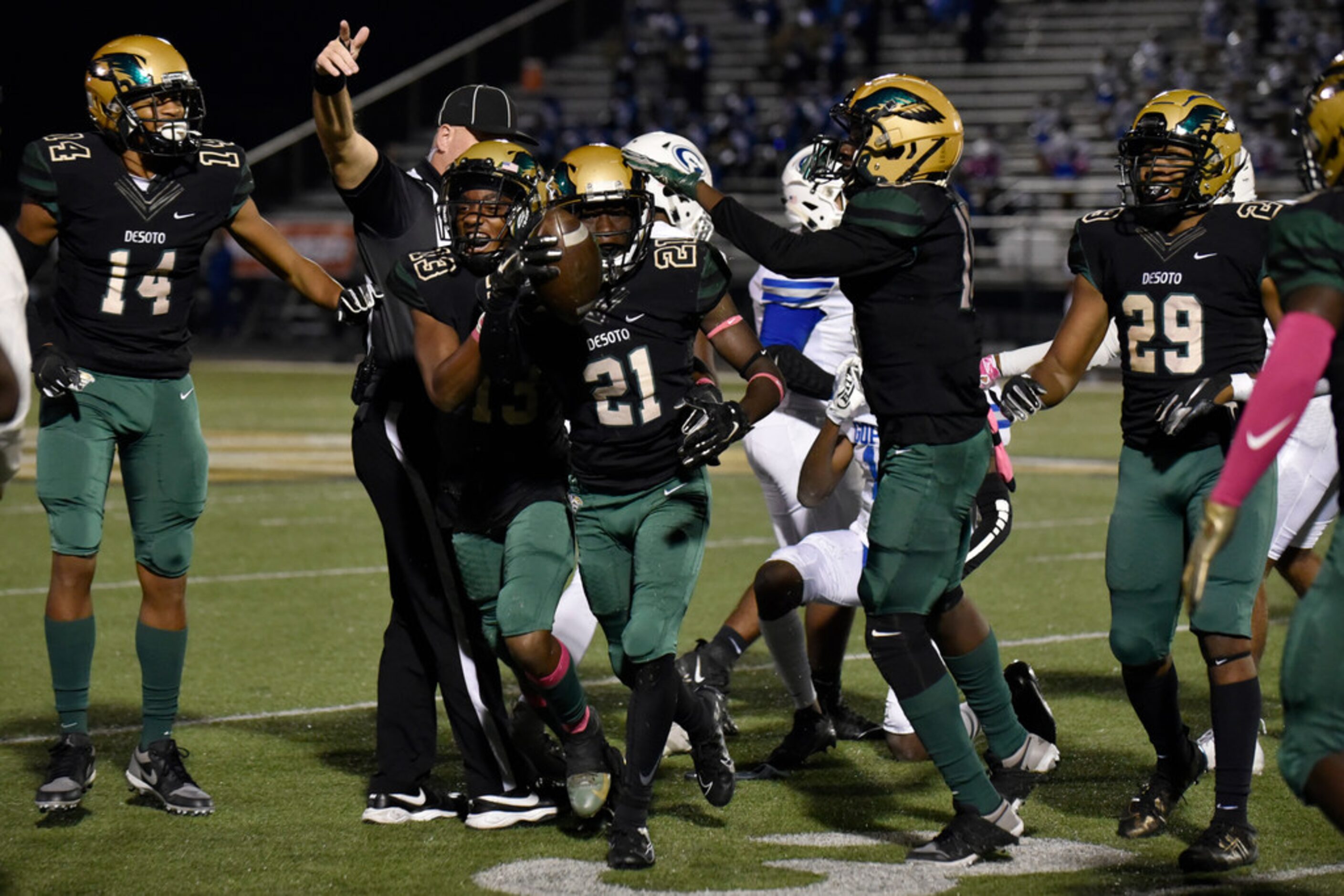 DeSoto High School senior defensive back Tylan Dangerfield (21) celebrates with teammates...