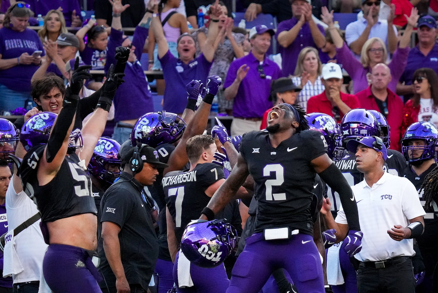 TCU safety Jamel Johnson (2) and linebacker Johnny Hodges (57) celebrate after a replay...