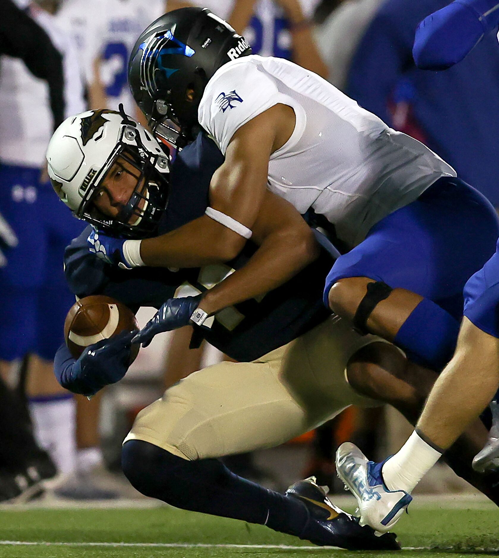 Keller wide receiver Amarion Henry (L) is brought down by Byron Nelson linebacker Ashton...