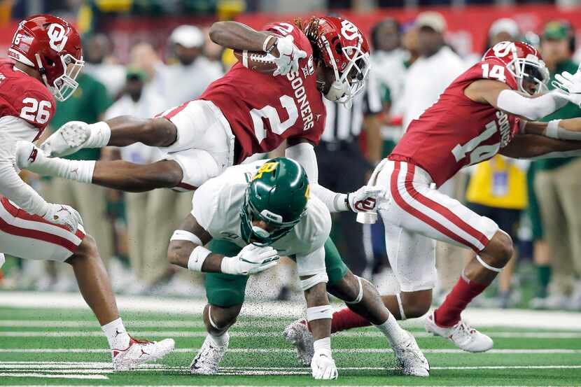 Oklahoma Sooners wide receiver CeeDee Lamb (2) flies over Baylor Bears cornerback Grayland...