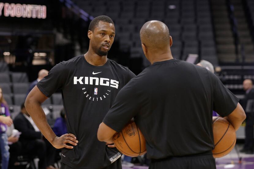 Newly acquired Sacramento Kings forward Harrison Barnes left, talks with Kings assistant...