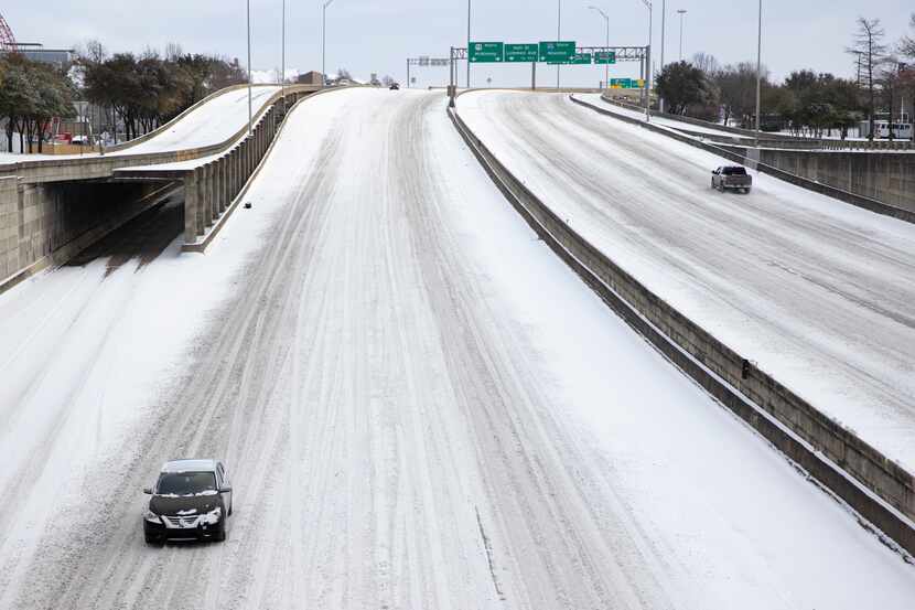 Snow covers Woodall Rodgers Freeway in Downtown Dallas on Monday.