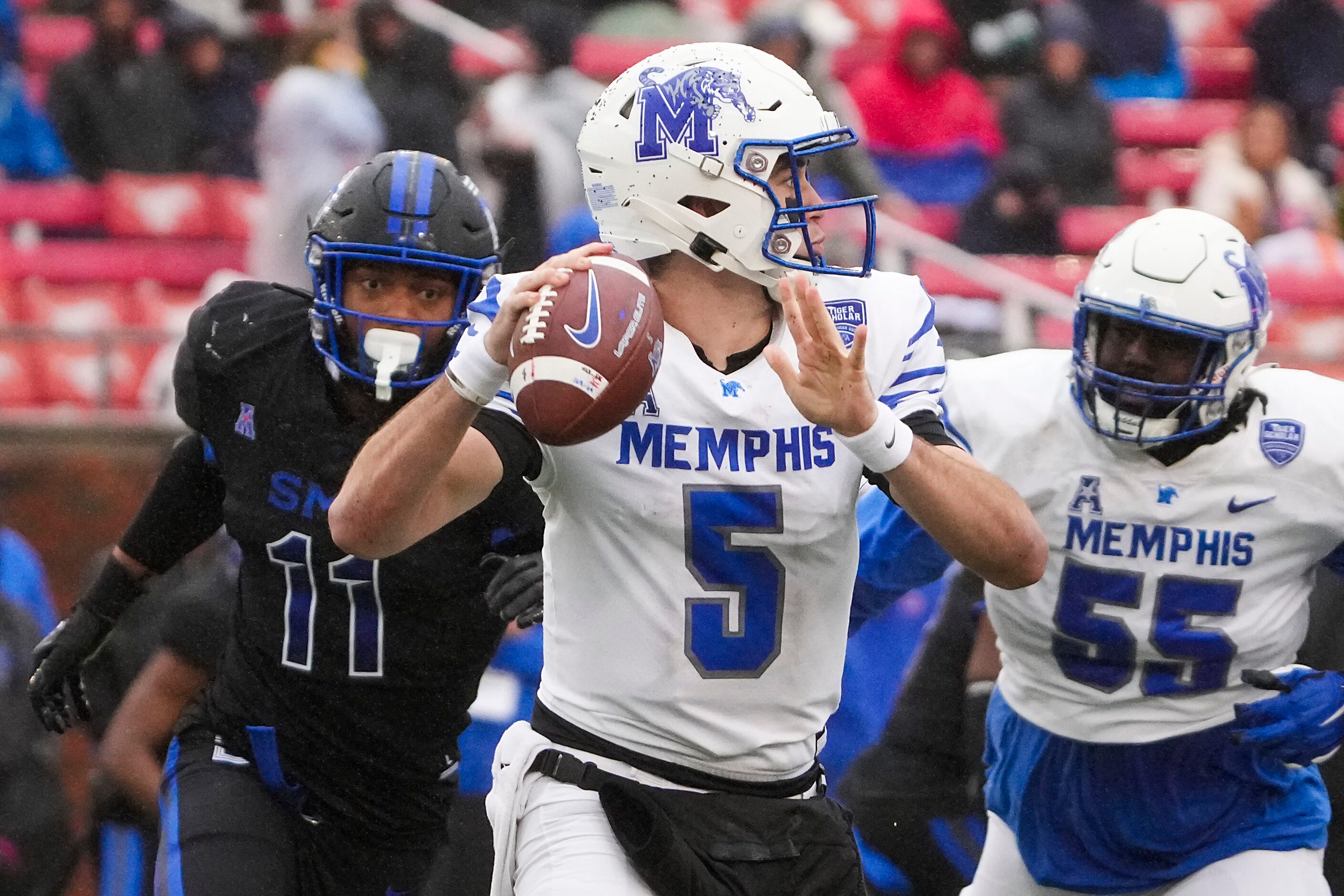 Memphis quarterback Seth Henigan (5) throws a pass under pressure from SMU defensive end...