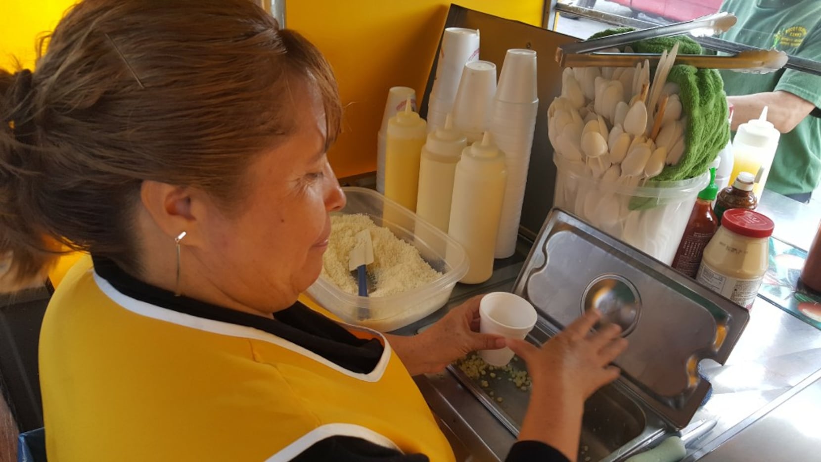 Susana Soto prepares the corn for an elote at Elotes Fanny on Harry Hines Boulevard in Dallas.