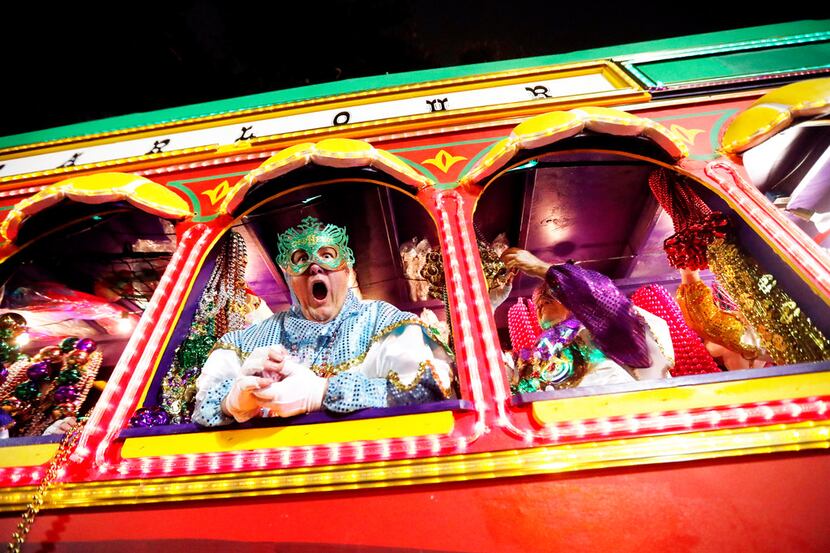 Float riders encourage the crowd as the Krewe of Orpheus rolls in New Orleans. (AP...