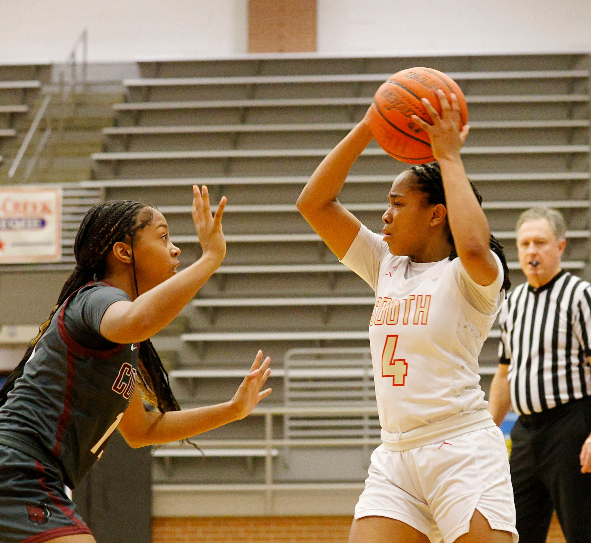 South Grand Prairie's Camille Mitchell (4) looks to pass the ball against Frisco Heritage's...