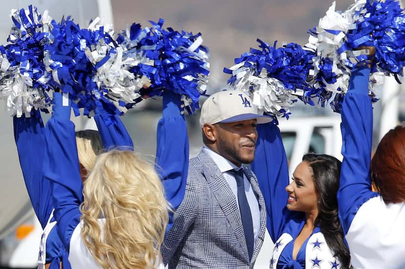 Dallas Cowboys defensive back Barry Church is greeted by the Dallas Cowboys Cheerleaders...
