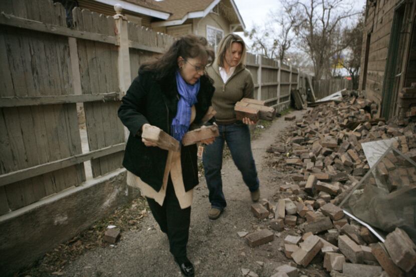 Belinda Ortiz (left) and Leisa McClelland grabbed bricks as souvenirs before Monday...