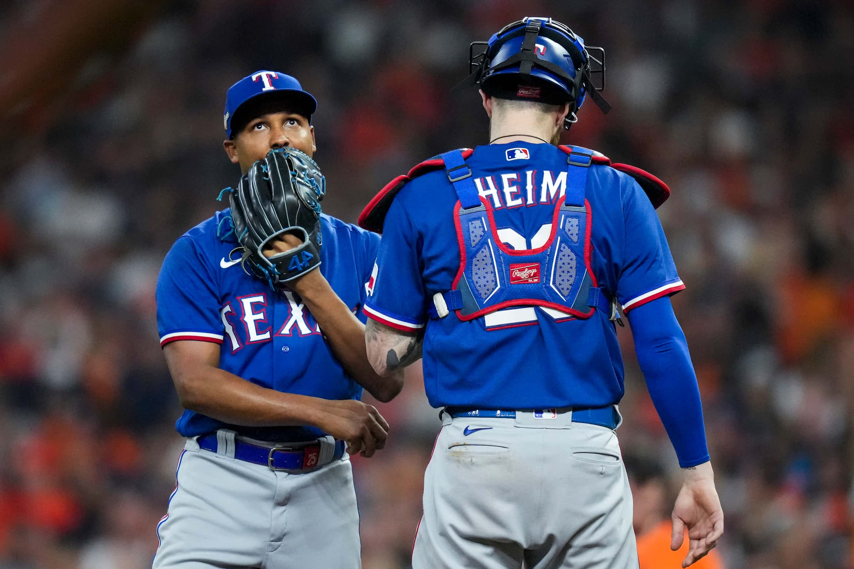 Texas Rangers relief pitcher Jose Leclerc gets a visit from catcher Jonah Heim before facing...
