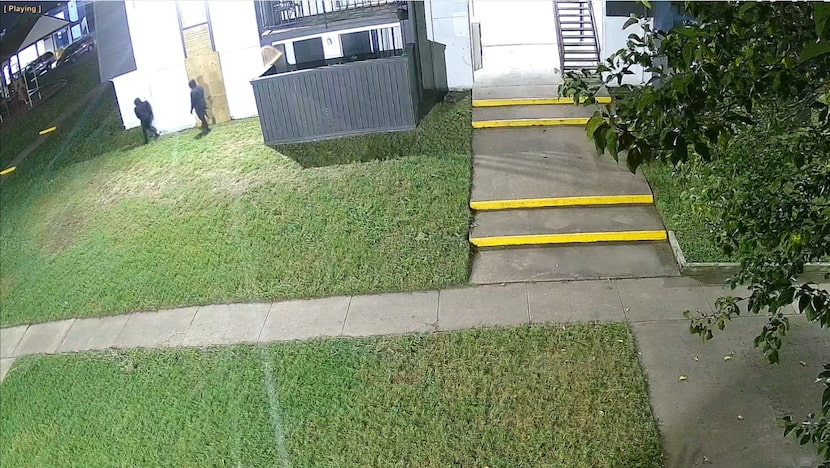 Surveillance footage from an apartment complex shows two suspects waiting around the corner...