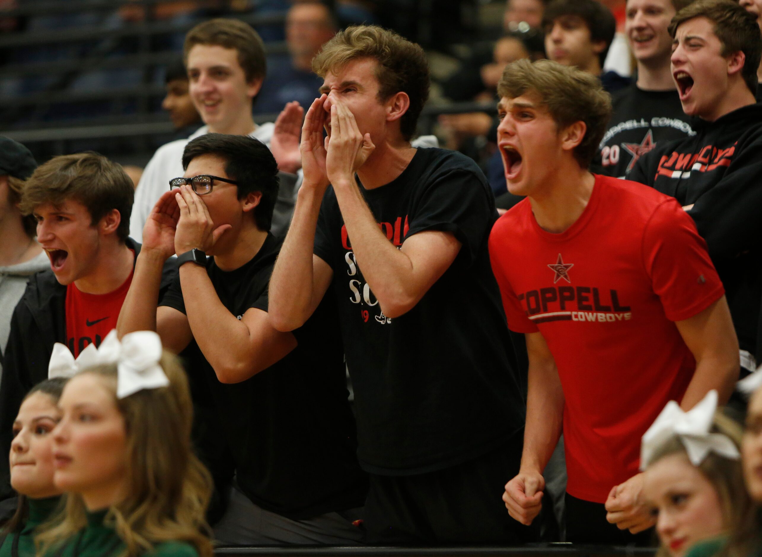 Coppell students voice their fan support during the first half against Waxahachie. The two...