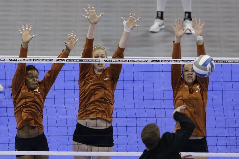 Texas' Chloe Collins, left, Sara Hattis, center, and Amy Neal go up for a block during...
