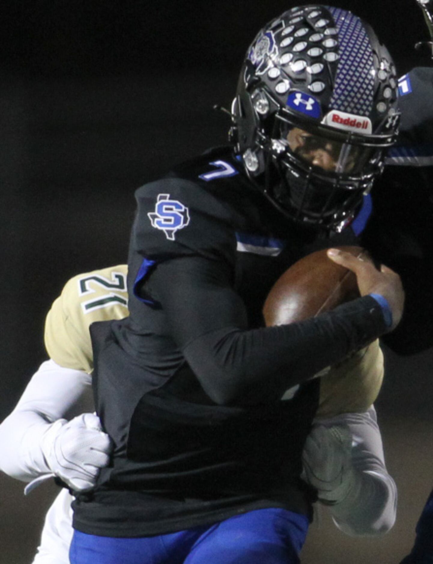 Mansfield Summit quarterback David Hopkins (7) is unable to elude the grasp of Birdville...