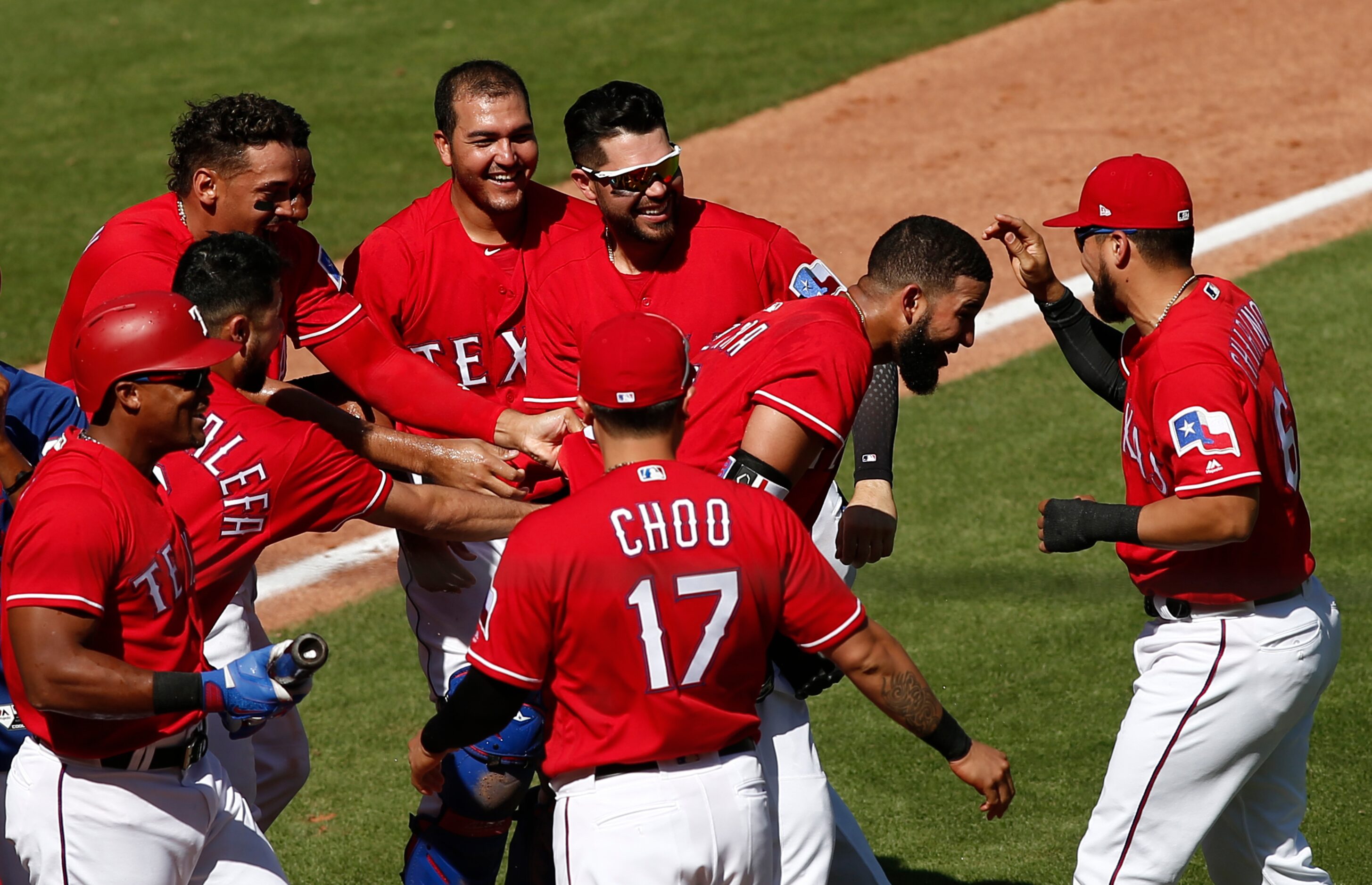 Texas Rangers' Nomar Mazara, second from right, celebrates with teammates after hitting a...