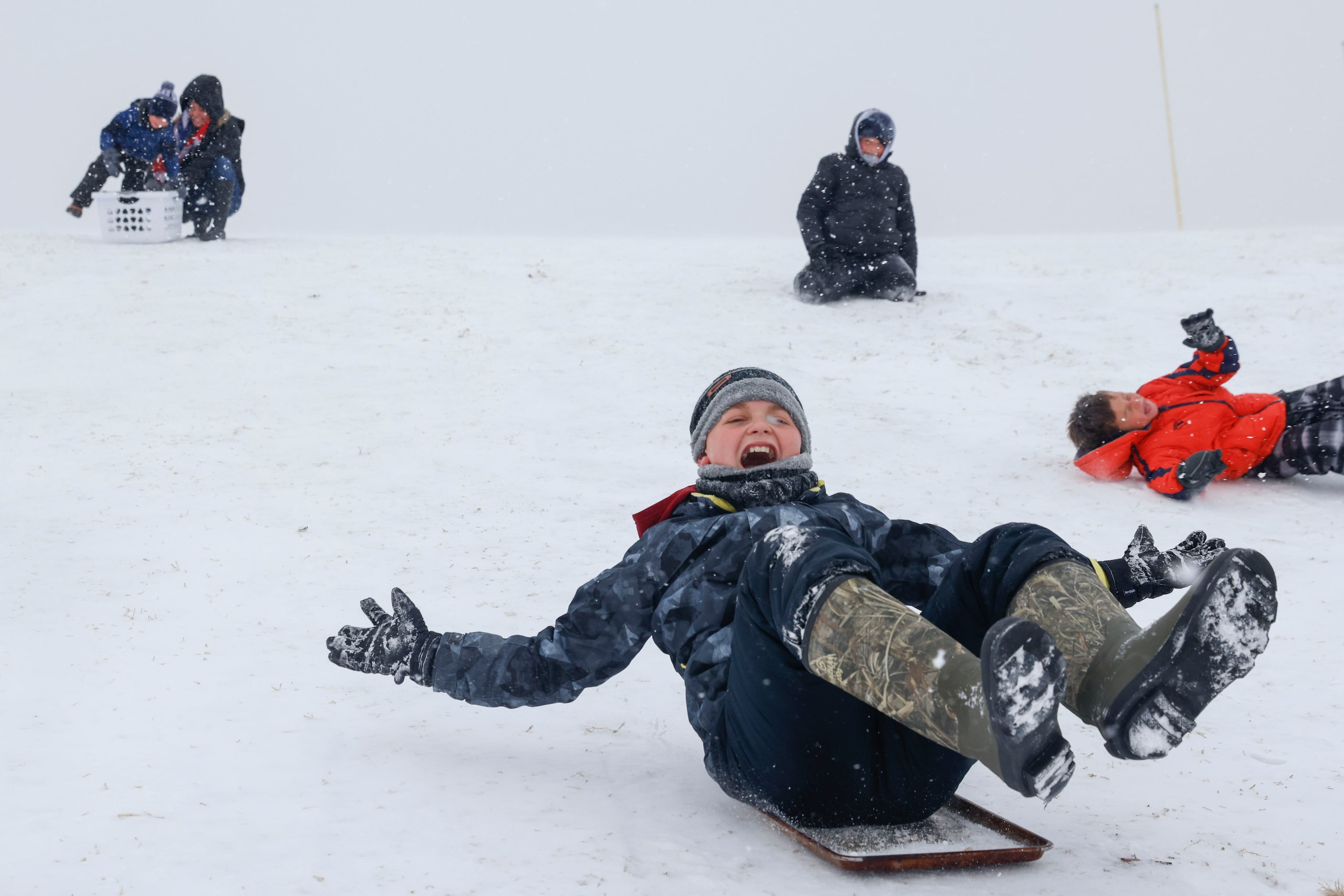 Pearce Smith reacts as he sleds during a snowfall on Thursday, Feb. 3, 2022 at Sue Wilson...