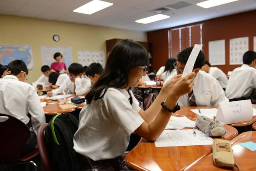 
Chinese exchange student Yu Qinyue works on an assignment in her Chinese language class at...