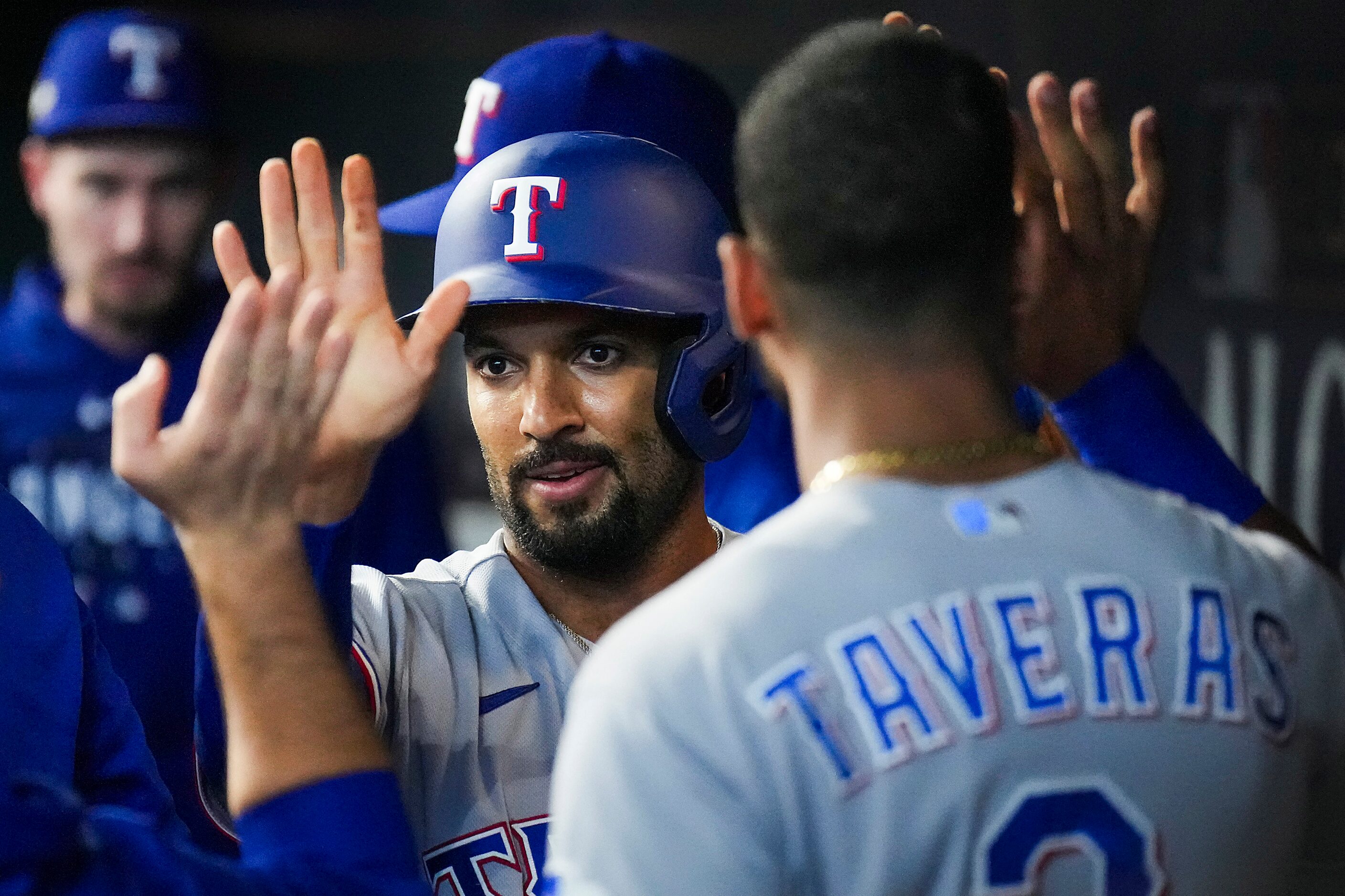 Texas Rangers second baseman Marcus Semien celebrates with center fielder Leody Taveras (3)...