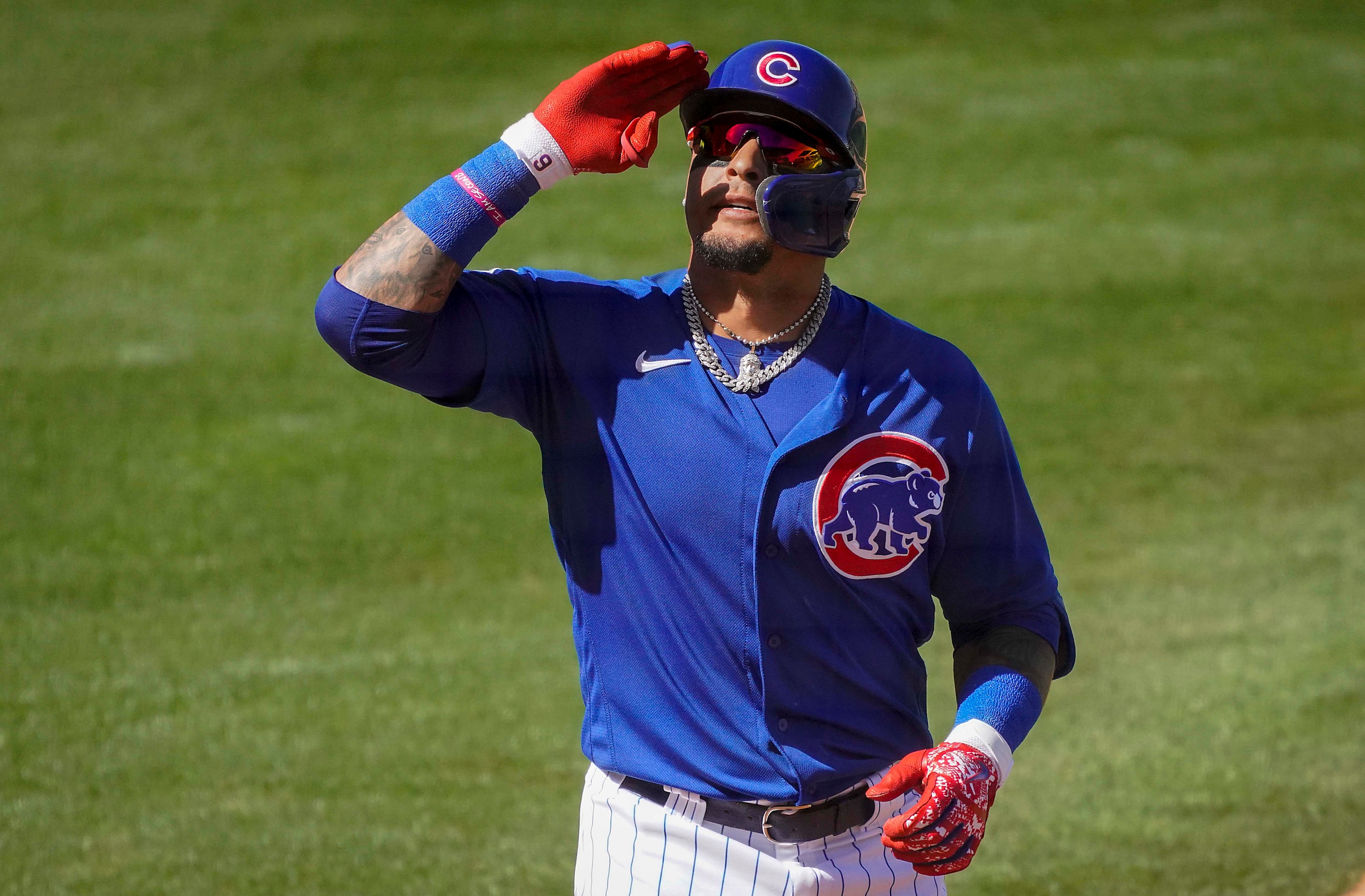 Chicago Cubs designated hitter Javier Baez celebrates after hitting a grand slam home run...