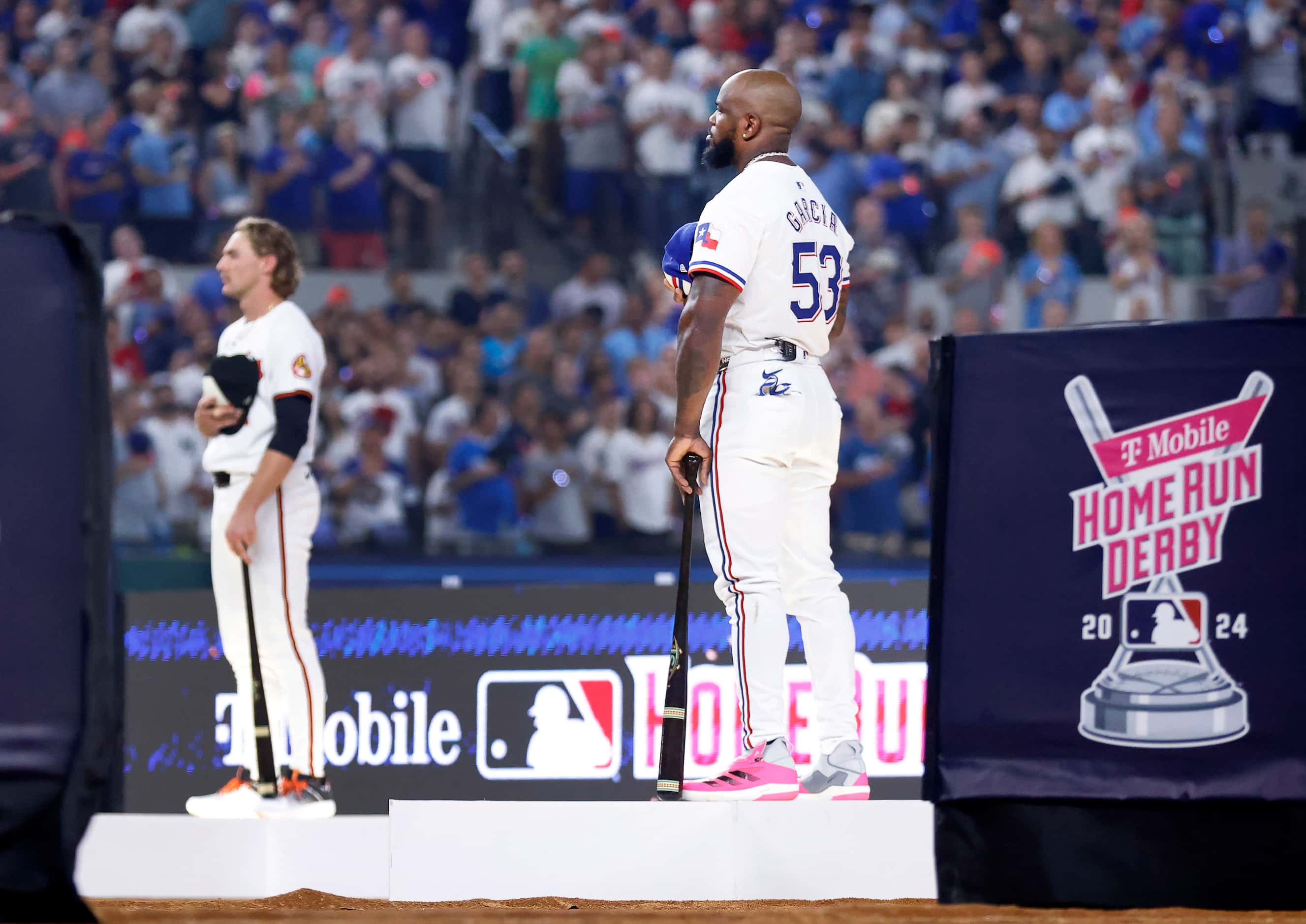 Texas Rangers outfielder Adolis Garcia and other competitors stand on lighted stars for the...