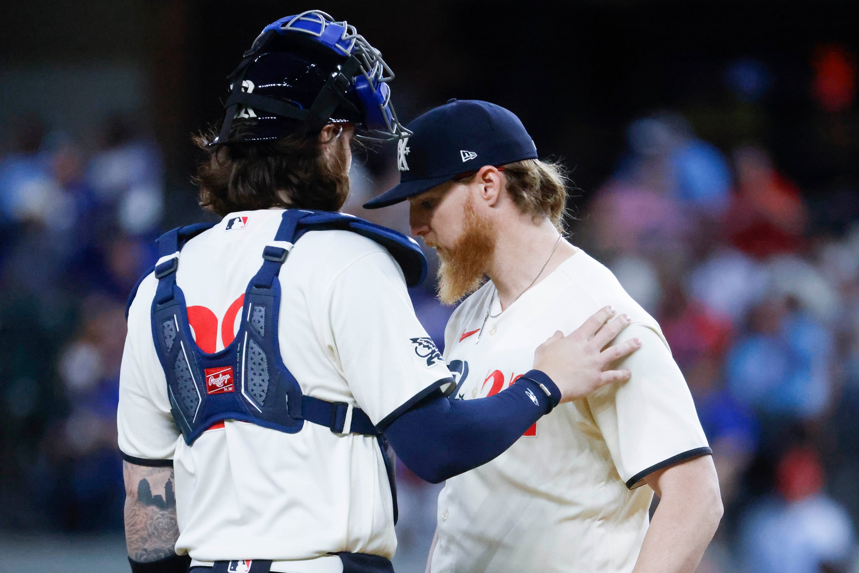 Texas Rangers catcher Jonah Heim (left) talks to starting pitcher Jon Gray during the third...