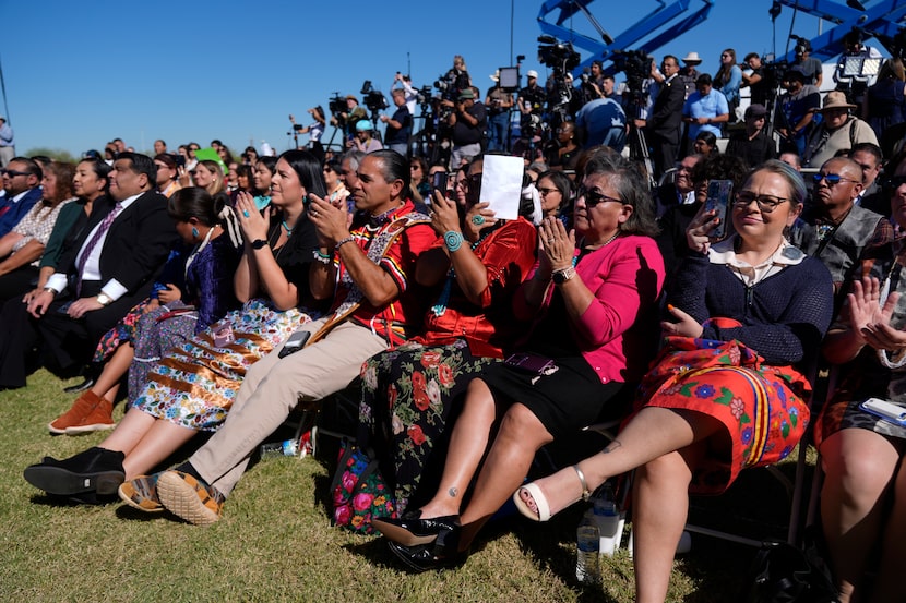 Attendees listen as Interior Secretary Deb Haaland speaks before President Joe Biden at the...