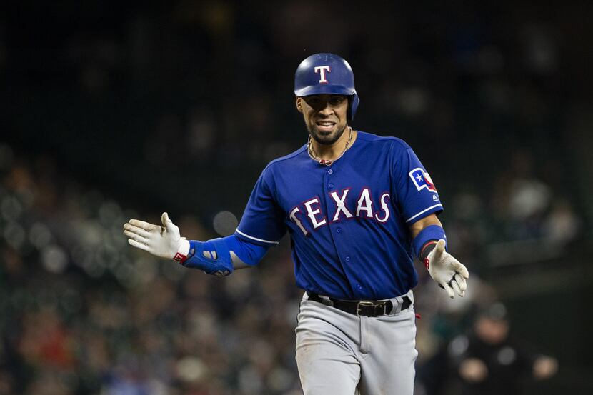 SEATTLE, WA - SEPTEMBER 28:  Robinson Chirinos #61 of the Texas Rangers claps his hands as...