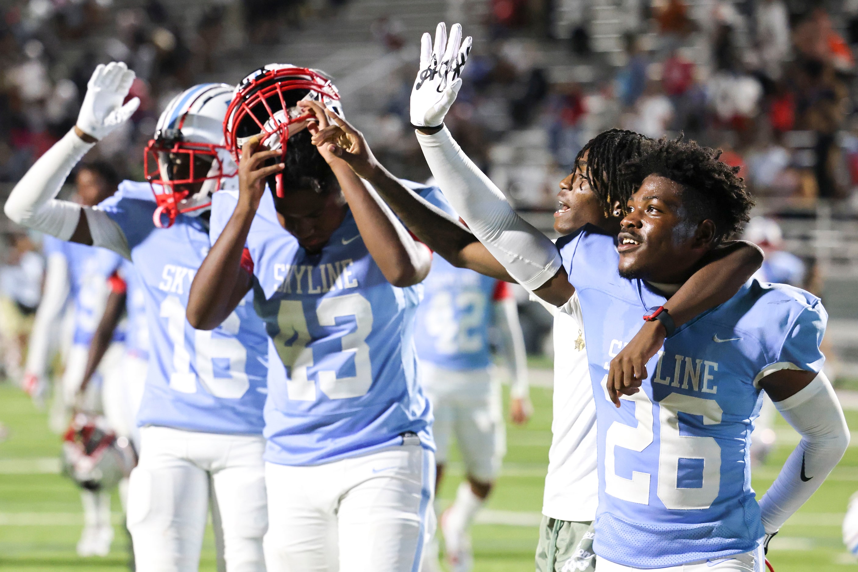 Skyline high players celebrate after winning a football game against North Forney, on...