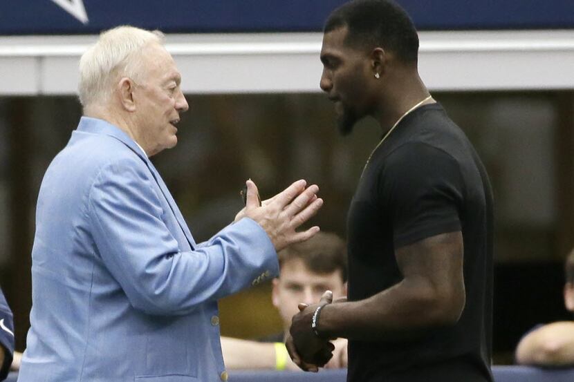 Dallas Cowboys wide receiver Dez Bryant, right, listens to team owner Jerry Jones on the...