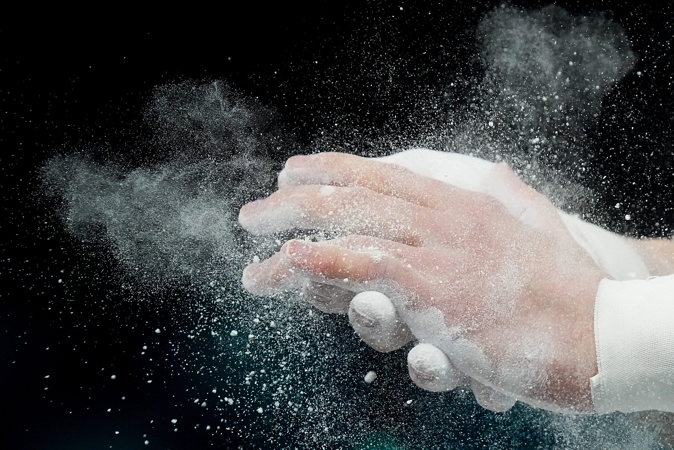 Paul Juda  of the United States chalks his hands before working out on the pommel horse...