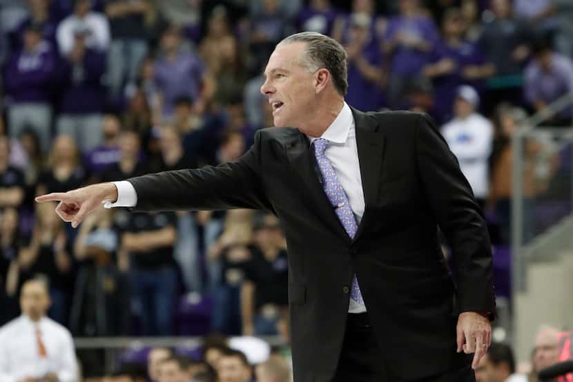 TCU head coach Jamie Dixon points from the sideline during the second half of an NCAA...