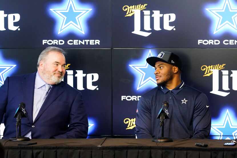 Dallas Cowboys first-round draft pick Micah Parsons (right) looks to head coach Mike...
