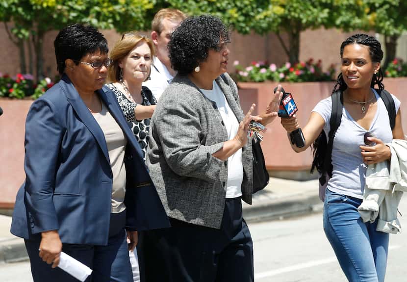 Kathy Nealy (left) walks behind her attorney Cheryl Wattley (center) after exiting the Earle...
