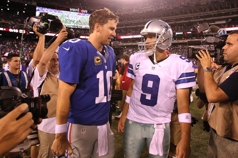 New York Giants quarterback Eli Manning (10) and Dallas Cowboys quarterback Tony Romo (9)...