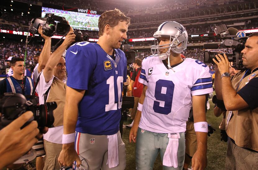 New York Giants quarterback Eli Manning (10) and Dallas Cowboys quarterback Tony Romo (9)...