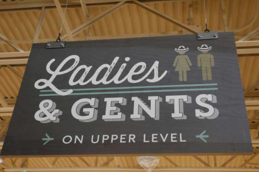 The figures on the restroom sign are pictured with cowboy hats at the Whole Foods store at...