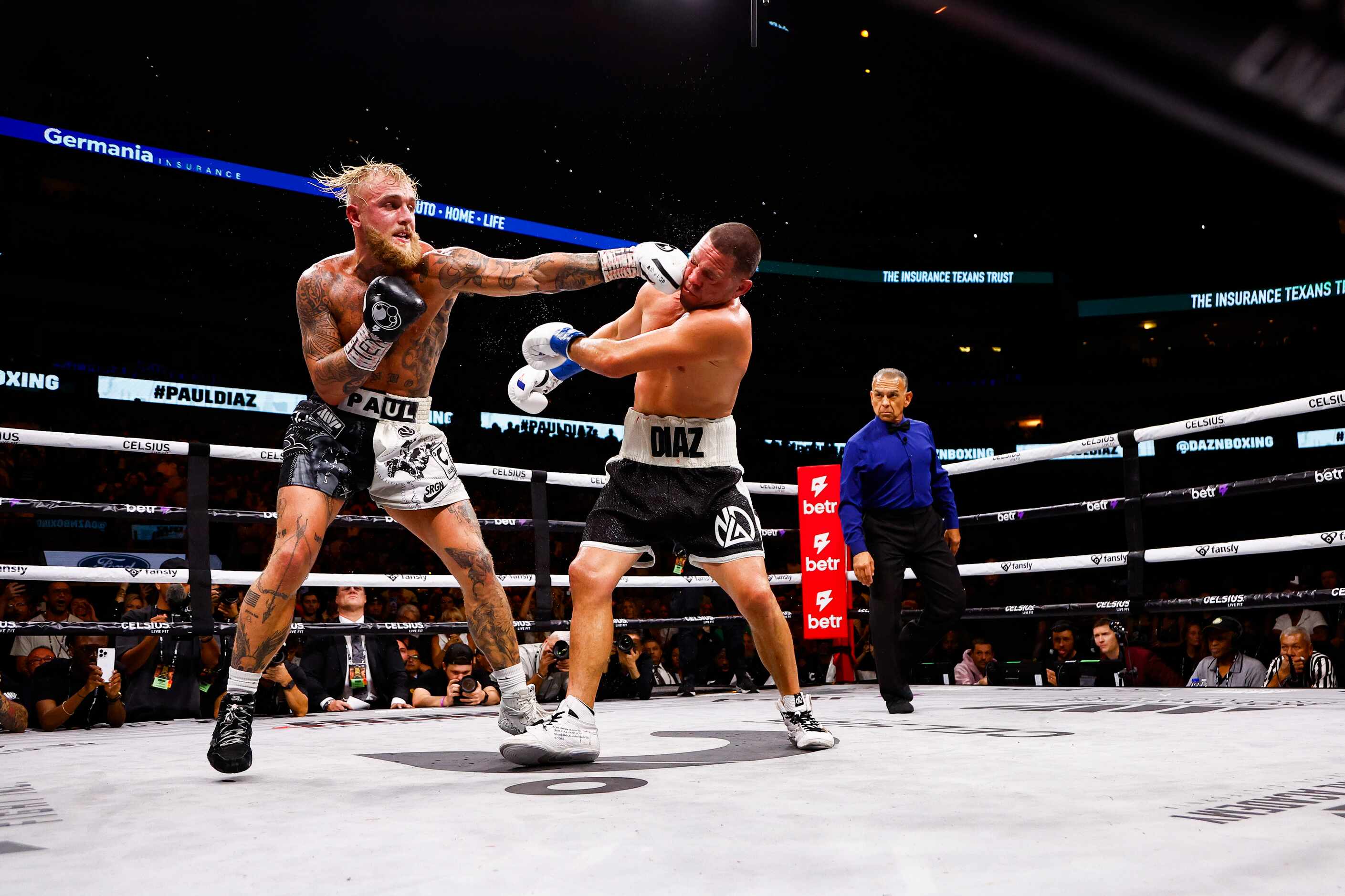 Jake Paul, left, lands a punch on Nate Diaz during a boxing match in Dallas, Saturday,...