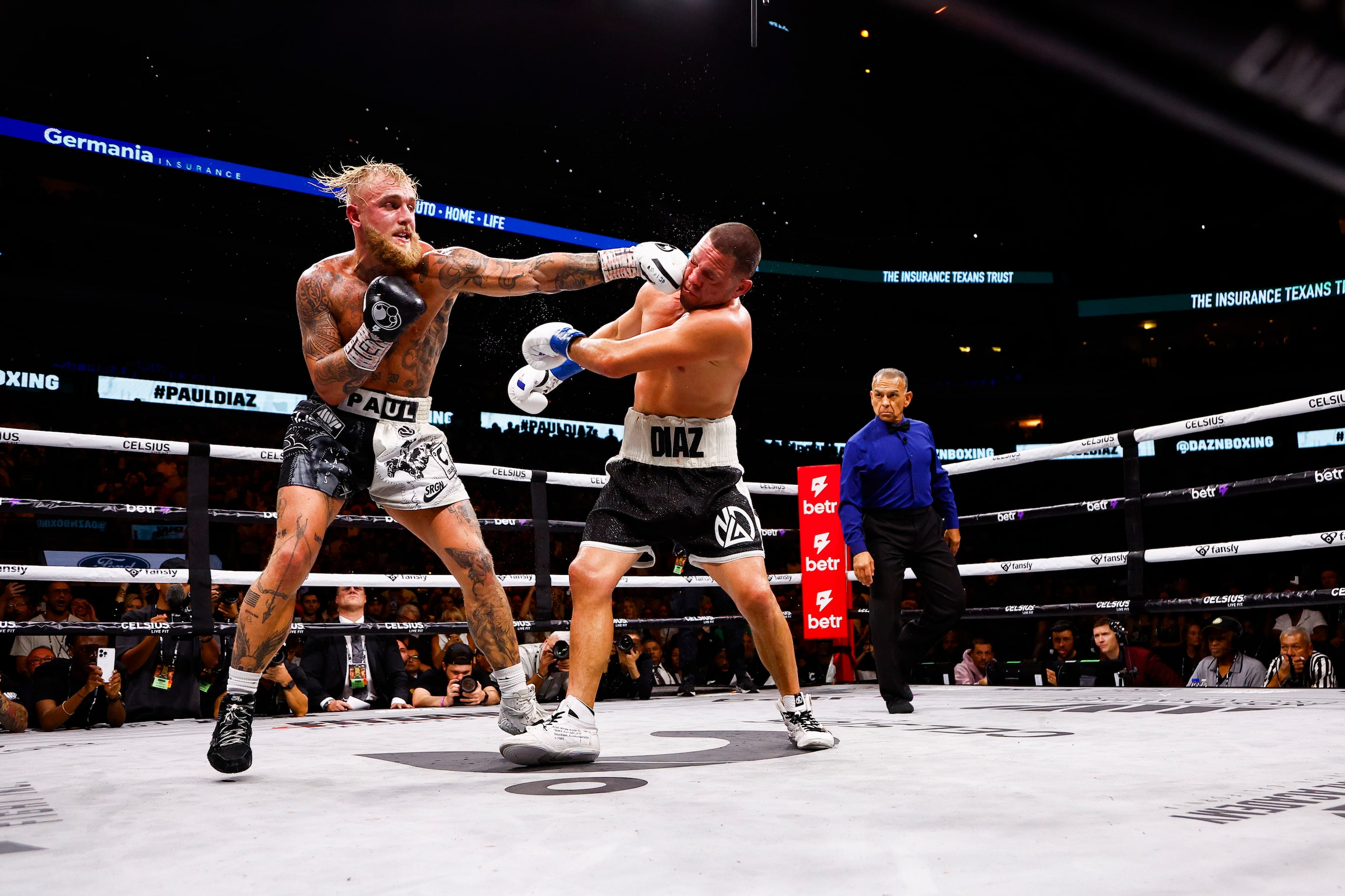 Jake Paul, left, lands a punch on Nate Diaz during a boxing match in Dallas, Saturday,...