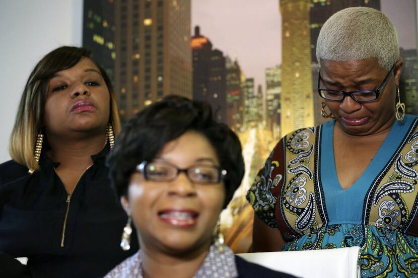  Sandra Bland's sister Sharon Cooper, front, take questions from the media, while her Shavon...