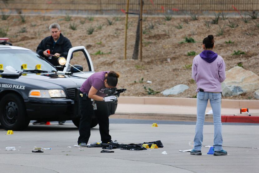 Members of the San Diego Police Department collect evidence at the scene of a fatal police...