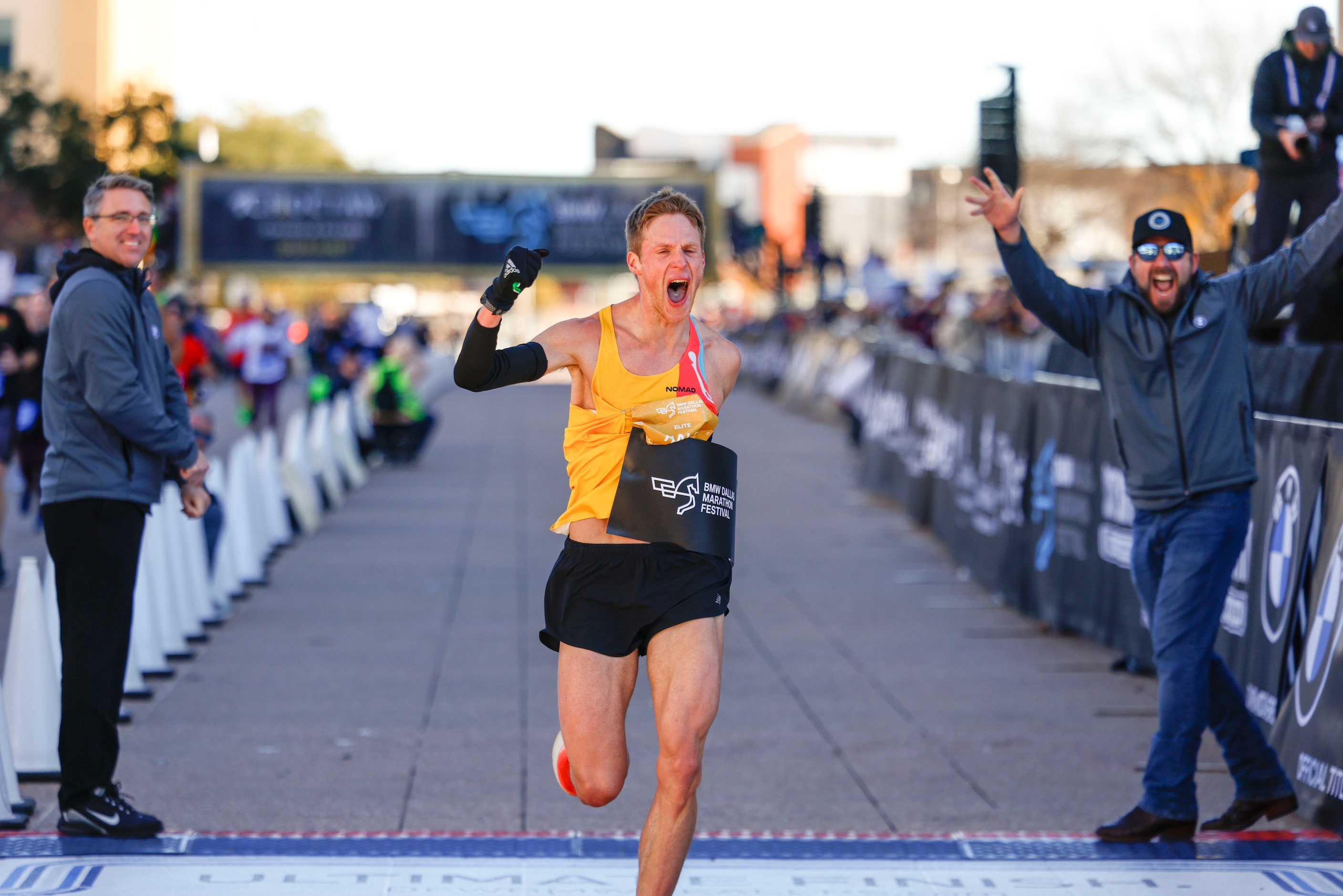 Men’s marathon finisher Joseph Hale, 30, of Grapevine, celebrates after reaching the finish...