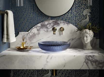 Blue glass sink on marble vanity