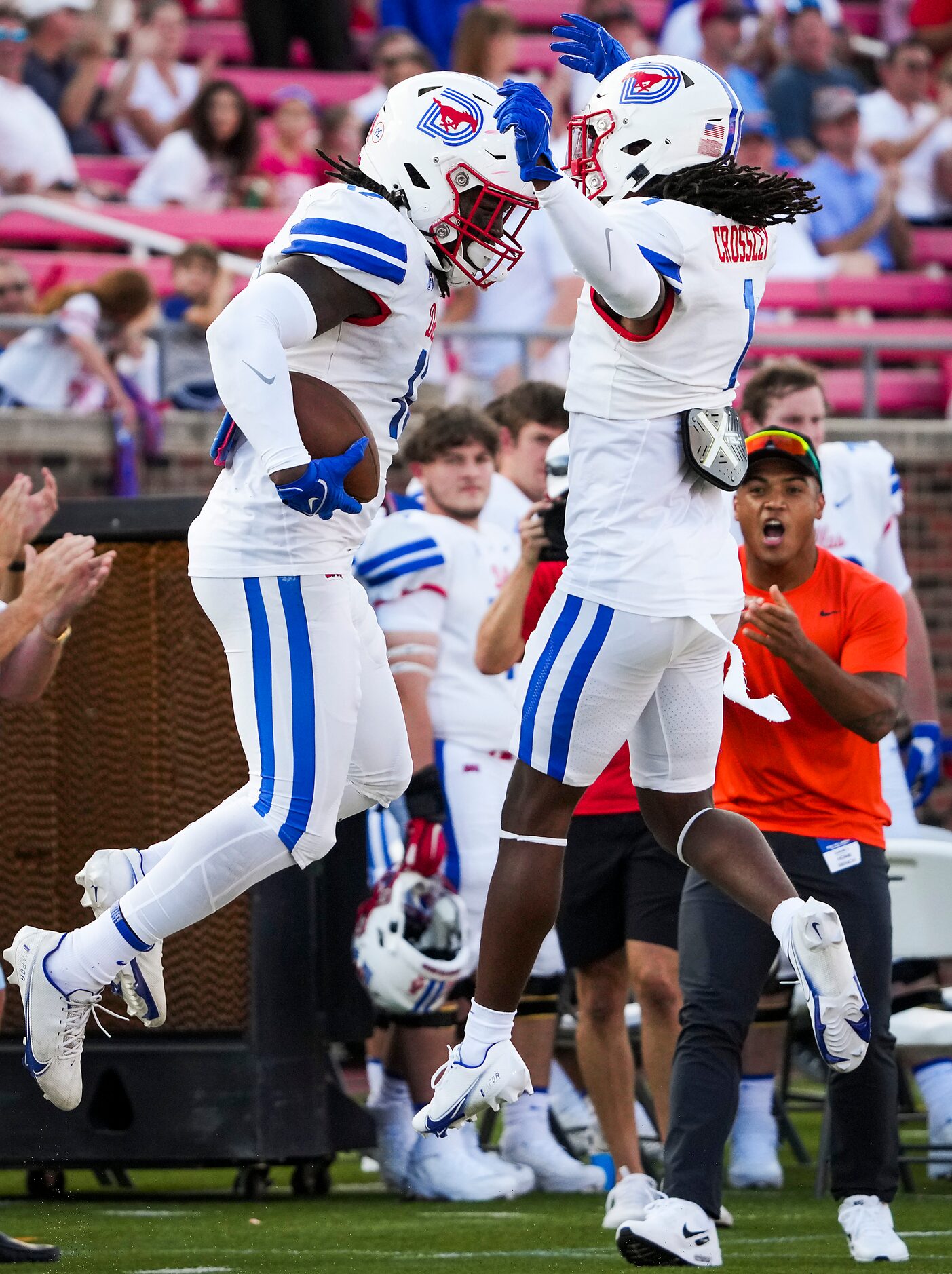 SMU linebacker Shanon Reid (12) celebrates with safety Brandon Crossley (1) after...