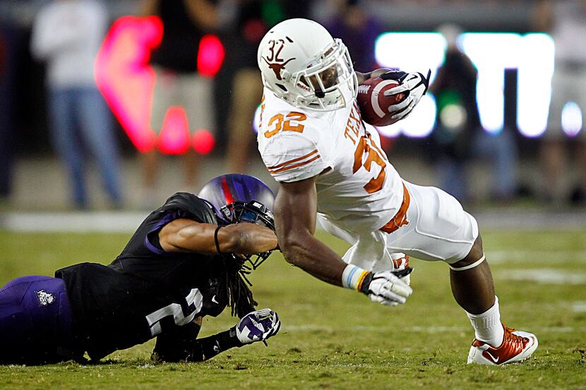 Texas Longhorns running back Johnathan Gray (32) spins to the ground after being snagged by...