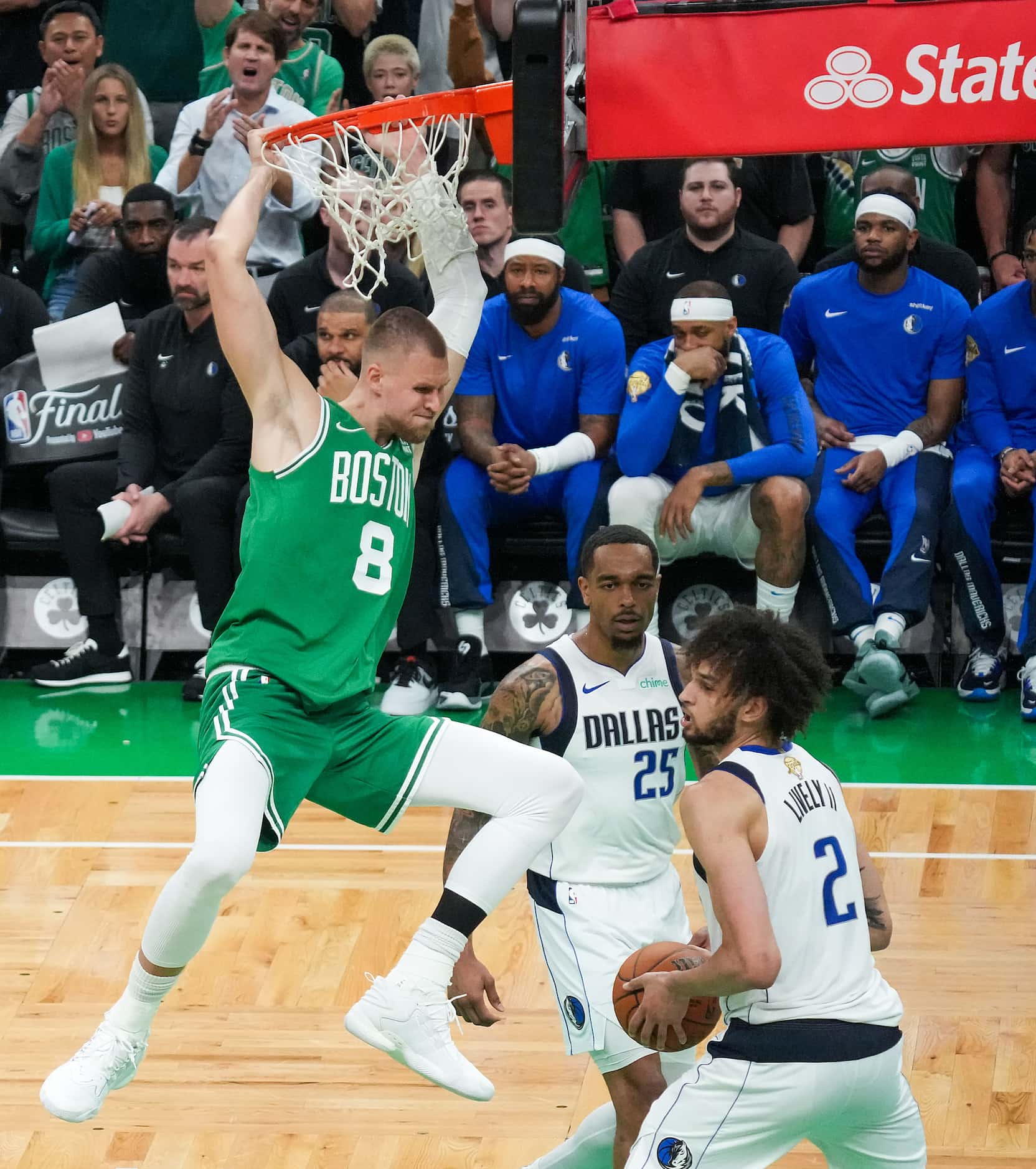Boston Celtics center Kristaps Porzingis (8) dunks the ball past Dallas Mavericks center...
