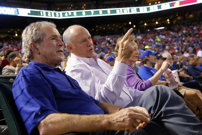 Former Texas Rangers president Nolan Ryan, right, shared the front row with former President...