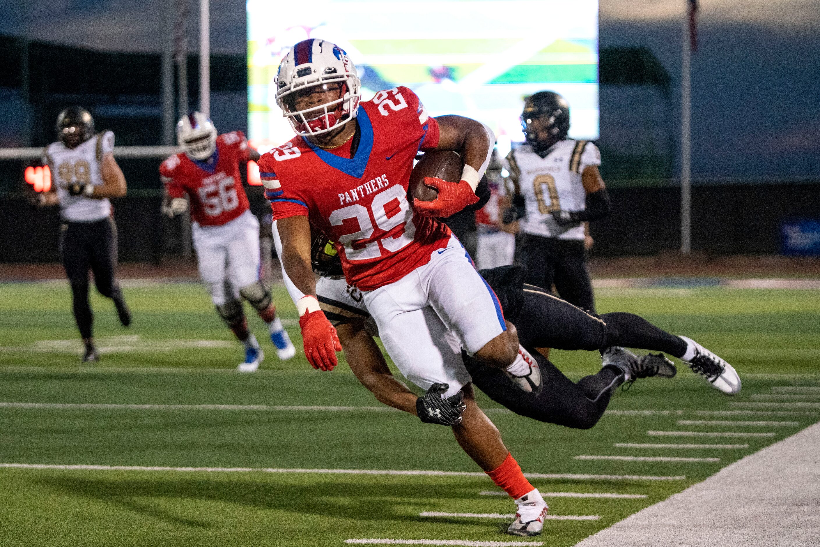 Duncanville junior running back Caden Durham (29) is brought down from behind by Mansfield...