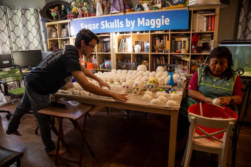 (From left) Avram Willams, 19, creates space on the table as mom, North Texas artist Maggie...