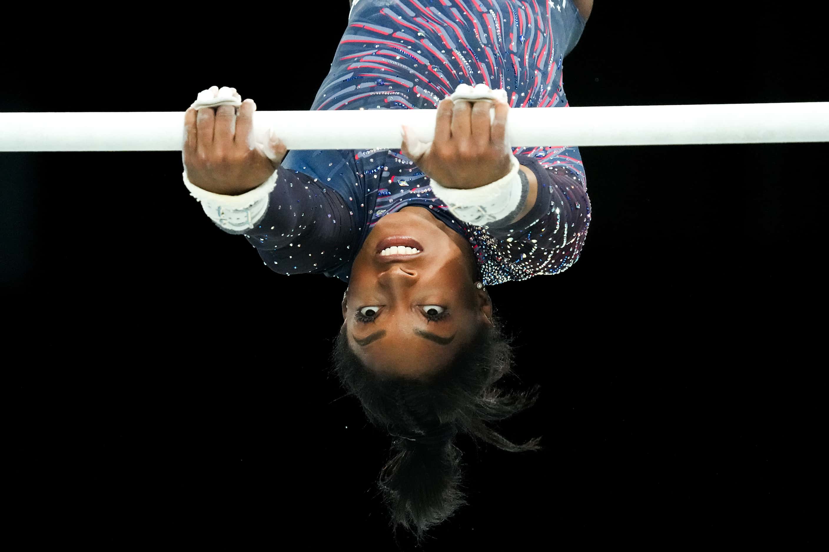 Simone Biles of the United States practices on the uneven bars during women’s gymnastics...