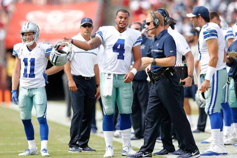 Dallas Cowboys quarterback Dak Prescott (4) talks with Dallas Cowboys head coach Jason...