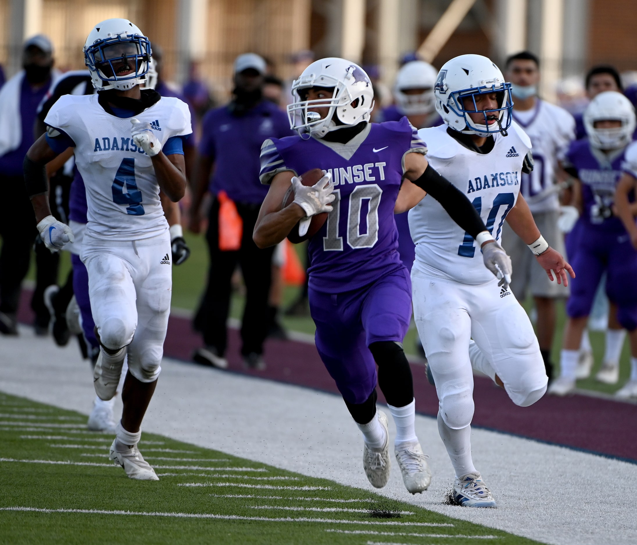 Sunset's Fernando Jasso (10) runs for a touchdown past Adamson's Isaiah Torres (4) and...